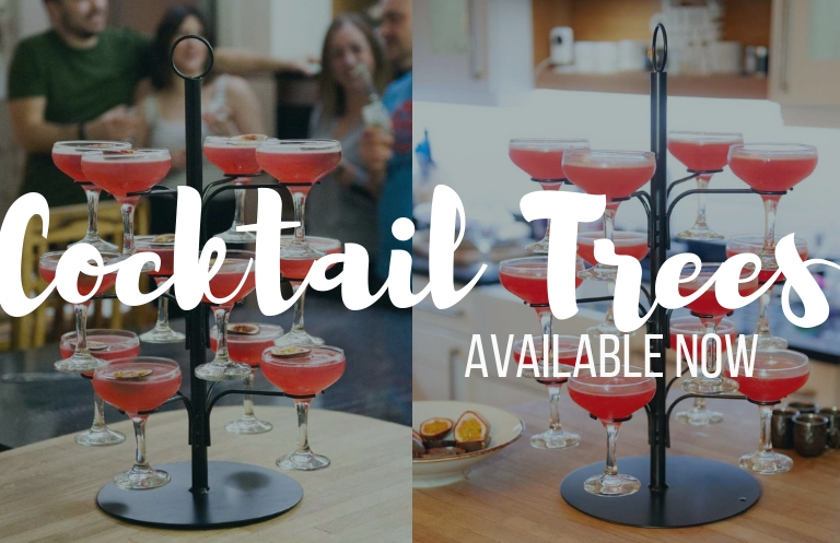 a cocktail tree filled with red drinks under the words cocktail trees available now