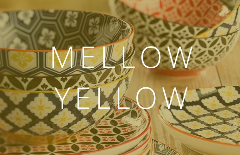 patterned plates and bowls and the words Mello Yellow