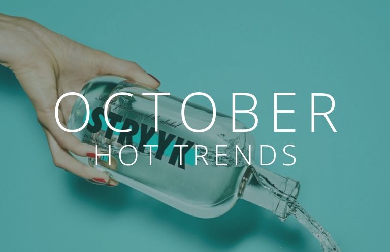 a hand pouring drink from a bottle behind the words October hot trends